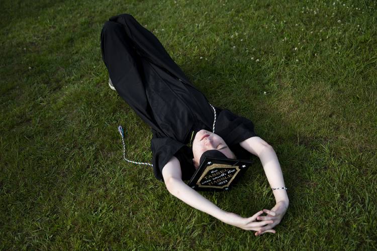 Kentin Rowell rests in the grass before his graduation ceremony at Newport High School in Newport, N.H., on Thursday, June 15, 2023. (Valley News / Report For America - Alex Driehaus) Copyright Valley News. May not be reprinted or used online without permission. Send requests to permission@vnews.com.