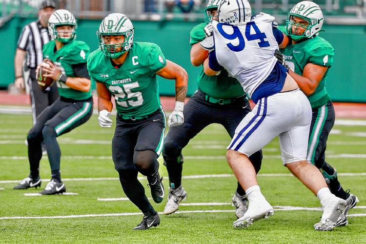 Dartmouth College running back Tevita Moimoi (25) moves out of the backfield while quarterback Jackson Proctor (12) drops back to pass against Yale on Oct. The 7, 2023, at Memorial Field in Hanover, N.H. Yale won the Ivy League contest, 31-24.