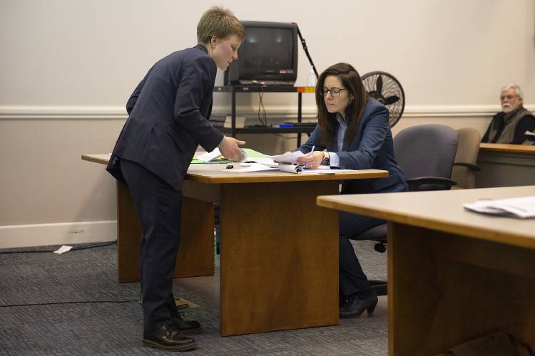 Defense attorney Kira Kelley, left, shows prosecutor Mariana Pastore a section of the Dartmouth Committee on Standards policy that will be referenced while questioning a witness at Lebanon District Court in Lebanon, N.H., on Monday, Feb. 26, 2024. (Valley News / Report For America - Alex Driehaus) Copyright Valley News. May not be reprinted or used online without permission. Send requests to permission@vnews.com.