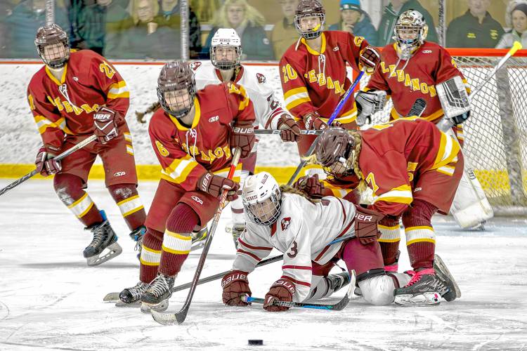 Hanover High's Hannah Gardner (3) is surrounded by Lebanon foes, including Sara Forman (6) and Mirabella Orlen (7) during their March 1, 2024, NHIAA Division I playoff quarterfinal at Campion Rink in West Lebanon, N.H. Hanover won, 3-0. (Paul Stinson photograph)