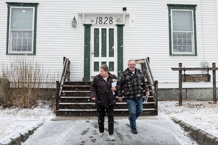 Barbara and Jim Harding exit Town Meeting into the beginnings of a snow storm in Croydon, N.H., on Saturday, March 12, 2022. (Valley News - James M. Patterson) Copyright Valley News. May not be reprinted or used online without permission. Send requests to permission@vnews.com.