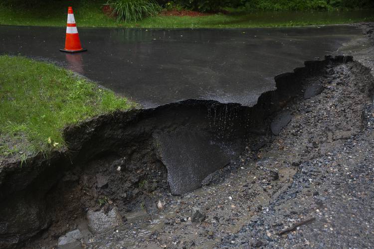 A cone alerts drivers to a collapsed driveway on South Road in Canaan, N.H., on Monday, July 10, 2023. (Valley News / Report For America - Alex Driehaus) Copyright Valley News. May not be reprinted or used online without permission. Send requests to permission@vnews.com.