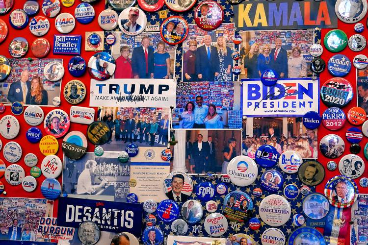 Current and past presidential candidate buttons, stickers and memorabilia are displayed on a wall in the visitors center at the New Hampshire Statehouse, Thursday, Oct. 12, 2023, in Concord, N.H. (AP Photo/Charles Krupa)