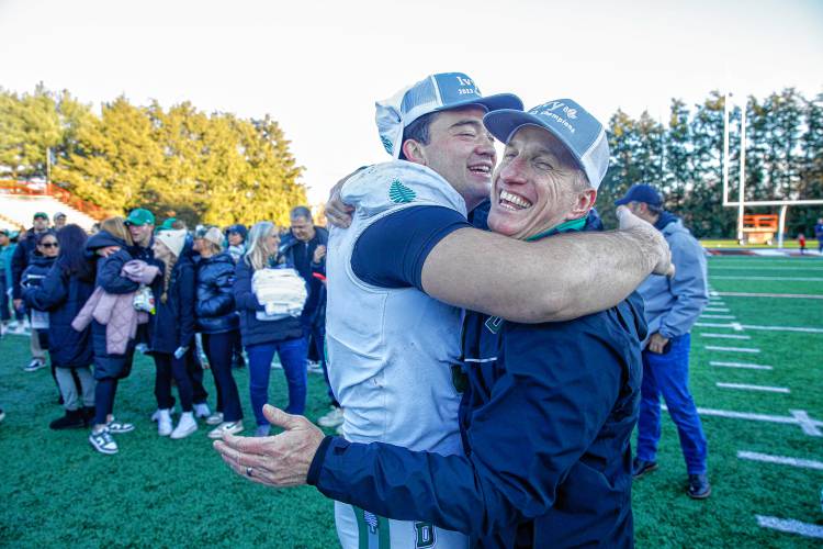 Dartmouth College football coach Sammy McCorkle, right, is wrapped in an embrace following the Big Green’s 38-13 win over Brown in Providence, R.I., on Saturday, Nov. 18, 2023. The win gave Dartmouth a share of its 21st Ivy League championship.