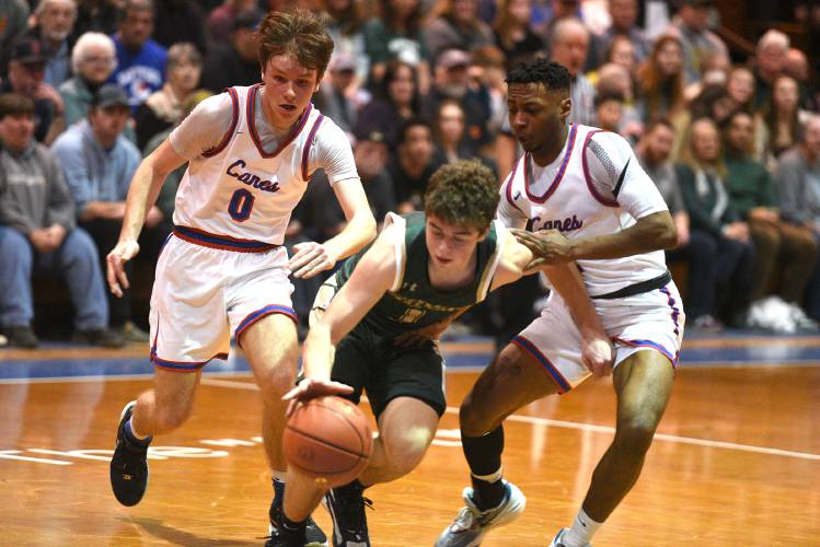 Hartford's Sean Dunton (0) and Evan Lynds (2) try to stop Montpelier's Carter Bruzzese during their game at the VPA D-II boys basketball championship in Barre, Vt., on Saturday, March 2, 2024. Montpelier won, 58-49. (Valley News - Jennifer Hauck) Copyright Valley News. May not be reprinted or used online without permission. Send requests to permission@vnews.com.