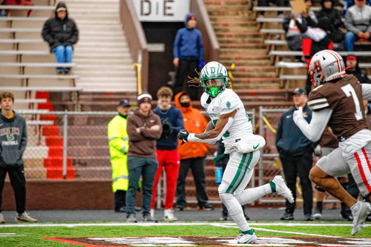 Dartmouth College running back Q Jones, center, looks back at Brown defensive back Aubrey Parker (7) en route to a 38-yard second-quarter TD run. Jones had a season-high 124 rushing yards and two scores.