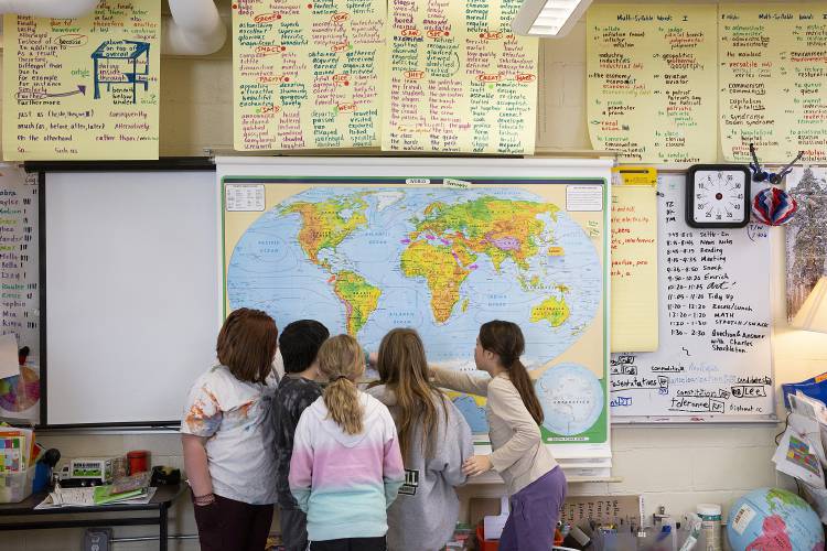 From left, fourth graders Lily Colon, Xander Shedd, Madison Champagne, Sophia Sinsigalli and Mia King find the location of Sir Ernest Shackleton’s ship Endurance, which sunk in the Weddell Sea off Antarctica in 1915, on a world map in their classroom at Samuel Morey Elementary School in Fairlee, Vt., on Tuesday, March 15, 2022. The discovery of the shipwreck by a group of researchers nearly 10,000 feet below the surface was announced last week. (Valley News / Report For America - Alex Driehaus) Copyright Valley News. May not be reprinted or used online without permission. Send requests to permission@vnews.com.