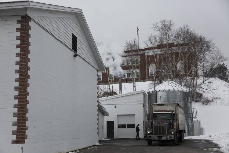 Lucas Perry, a truck driver for Froling Energy, unloads a delivery of wood chips, which power Sunapee Elementary School’s biomass heating system located next to the Sherburne Gym in Sunapee, N.H., on Thursday, Feb. 1, 2024. Ten tons of the hardwood chips, which run about $150 per ton, are delivered to the school every two weeks. (Valley News / Report For America - Alex Driehaus) Copyright Valley News. May not be reprinted or used online without permission. Send requests to permission@vnews.com.