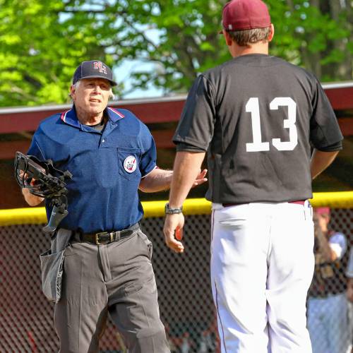 Baseball umpire Pete DePalo speaks with Hanover High coach John Grainger during a May 26, 2022, game at the Dresden Fields athletic complex in Norwich, Vt. (Valley News - Tris Wykes) Copyright Valley News. May not be reprinted or used online without permission. Send requests to permission@vnews.com.