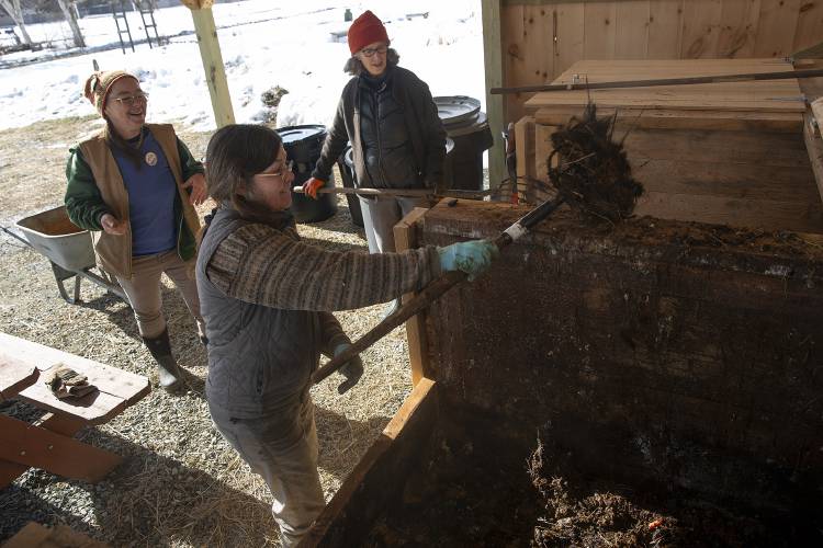 From left, master composters Cat Buxton, of Sharon, Vt., Lisa Burg, of Granville, Vt., and Abby Foulk, of Tunbridge, Vt., turn over Sharon Elementary School’s compost pile during the Sharon Skill Swap in Sharon, Vt., on Saturday, Feb. 10, 2024. Community composting was one of 20 different classes and workshops offered by volunteers throughout the day. (Valley News / Report For America - Alex Driehaus) Copyright Valley News. May not be reprinted or used online without permission. Send requests to permission@vnews.com.