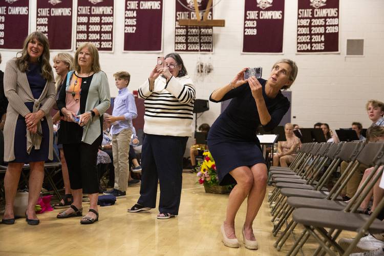 Allison Winchester, right, tries to get the attention of her daughter Ava Winchester to take a photo before her graduation ceremony at Hanover High School in Hanover, N.H., on Friday, June 9, 2023. (Valley News / Report For America - Alex Driehaus) Copyright Valley News. May not be reprinted or used online without permission. Send requests to permission@vnews.com.