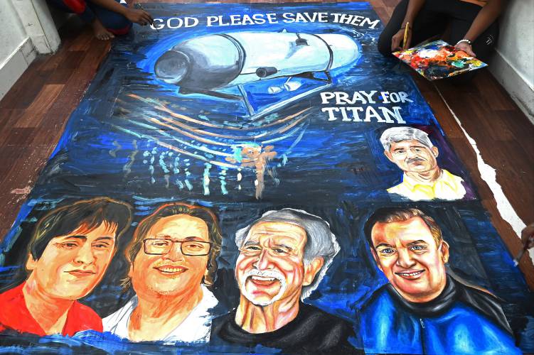 Art school students in Mumbai, India, give final touches to a painting depicting the five people aboard the Titan submersible that went missing near the wreck of the Titanic. (Indranil Mukherjee/AFP/Getty Images/TNS)