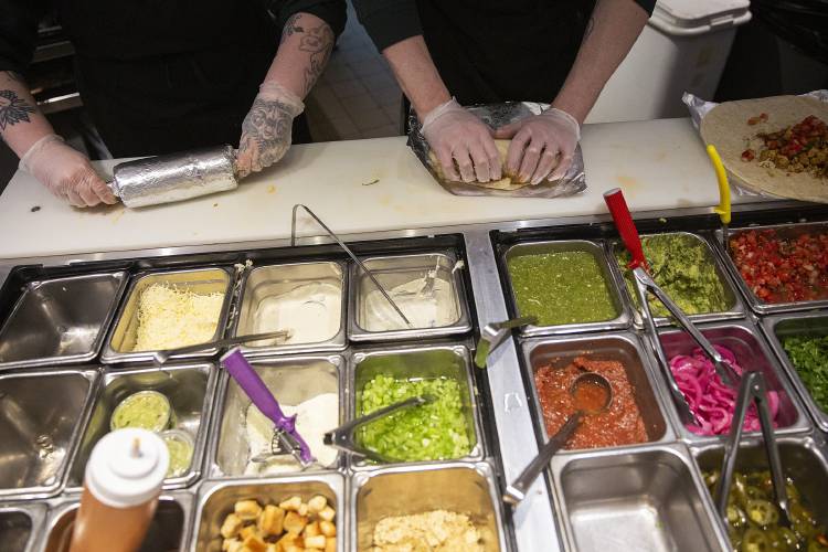 Emily Sohlstrom, left, and Birken Silitch make burritos for a customer order at Boloco in Hanover, N.H., on Thursday, Feb. 15, 2024. The restaurant’s Hanover location has been open for 20 years. (Valley News / Report For America - Alex Driehaus) Copyright Valley News. May not be reprinted or used online without permission. Send requests to permission@vnews.com.