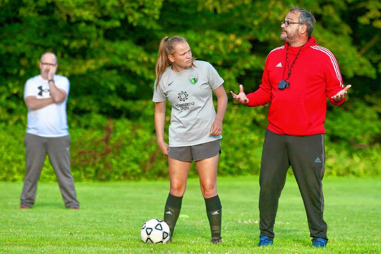Stevens High soccer player Kayleigh Ferland hangs on coach Tim St. Pierre’s every word during the Cardinals’ Aug. 14, 2023, practice at Monadnock Park in Claremont, N.H. (Valley News - Tris Wykes) Copyright Valley News. May not be reprinted or used online without permission. Send requests to permission@vnews.com.