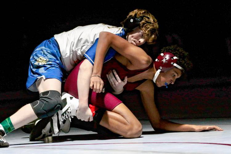 Lebanon High's Oden Mangani, bottom, battles Bow's Joshua Roos during an NHIAA Division III meet on Dec. 13, 2023, in Lebanon, N.H. Bow won, 54-12.  (Valley News - Tris Wykes) Copyright Valley News. May not be reprinted or used online without permission. Send requests to permission@vnews.com.