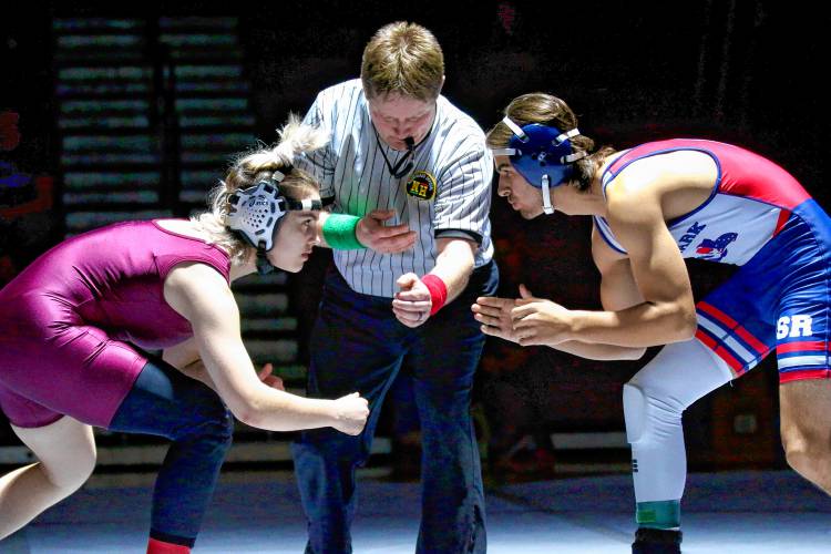 Lebanon High's Aero Buzby, left, prepares to wrestle John Stark's Brennan Champagne during a 144-pound bout on Dec. 13, 2023, in Lebanon, N.H. John Stark won, 66-18.  (Valley News - Tris Wykes) Copyright Valley News. May not be reprinted or used online without permission. Send requests to permission@vnews.com.
