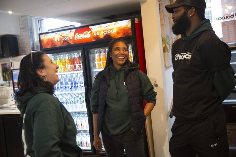 Paulina Gonzalez, left, Director of Operations for Boloco in Boston, talks to the new owners of the Hanover location, CJ Jackson, center, and Shamar Shand at Boloco in Hanover, N.H., on Thursday, Feb. 15, 2024. (Valley News / Report For America - Alex Driehaus) Copyright Valley News. May not be reprinted or used online without permission. Send requests to permission@vnews.com.