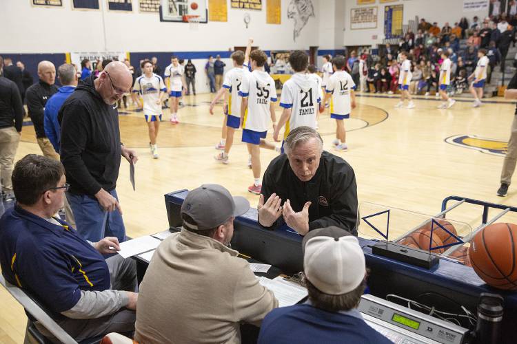 International Association of Approved Basketball Officials referee Peter DePalo, center, talks to scorekeepers before the start of the NHIAA Division III boys basketball semifinal game between Conant High School and Kearsarge Regional High School held at Bow High School in Bow, N.H., on Tuesday, Feb. 20, 2024. (Valley News / Report For America - Alex Driehaus) Copyright Valley News. May not be reprinted or used online without permission. Send requests to permission@vnews.com.
