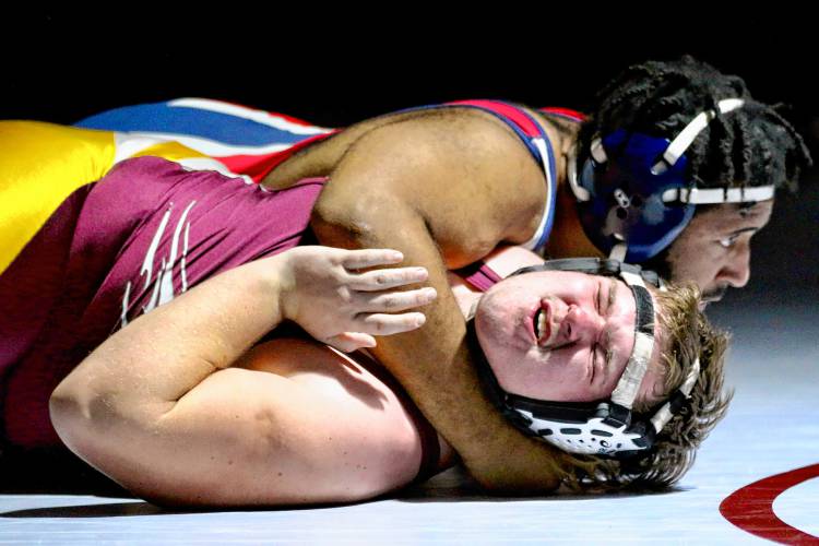 Lebanon High's Chris Kinne grimaces while attempting to escape the hold of John Stark's Isaac Coker during a 285-pound match between the NHIAA Division III teams on Dec. 13, 2023, in Lebanon, N.H. John Stark won, 66-18. (Valley News - Tris Wykes) Copyright Valley News. May not be reprinted or used online without permission. Send requests to permission@vnews.com.