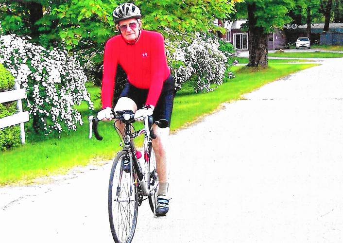 Royal Houghton on one of his many bicycles, in front of his house in an early 2000s photograph. (Family photograph)