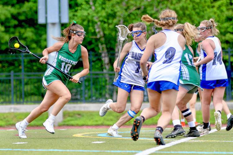 Woodstock High's Hannah Gubbins (10) drives against U32 defenders during the Vermont Division II title game on June 10, 2023, at Norwich University in Northfield, Vt. U32 won, 8-4. (Valley News - Tris Wykes) Copyright Valley News. May not be reprinted or used online without permission. Send requests to permission@vnews.com.