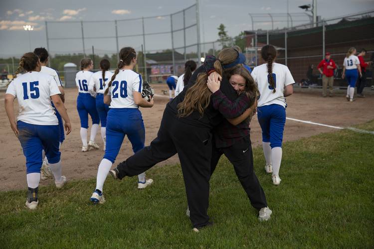 Hartford head coach Danielle Tenney, left, hugs Hailie Defabiis, a former Hartford softball player who graduated last year, after a VPA Division II softball quarterfinal game against Rice Memorial High School at Maxfield Sports Complex in White River Junction, Vt., on Monday, June 5, 2023. Hartford won, 22-7. (Valley News / Report For America - Alex Driehaus) Copyright Valley News. May not be reprinted or used online without permission. Send requests to permission@vnews.com.