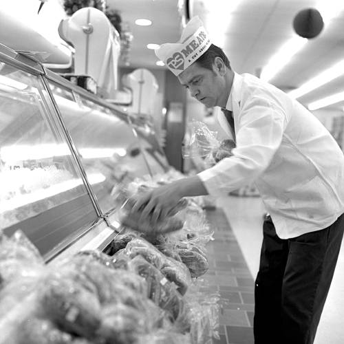 Joseph MacGuerty, delicatessen manager, passes the time on Purity Supreme's 