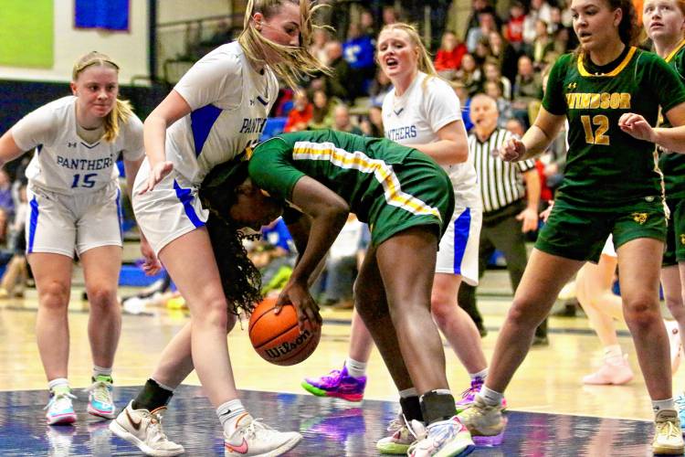 Windsor High's Kemari Wildgoose, with ball, collides with Thetford Academy's Ruth Wilmott during the Vermont Division III teams' game on Dec. 21, 2023, in Thetford, Vt. Windsor won, 41-31. (Valley News - Tris Wykes) Copyright Valley News. May not be reprinted or used online without permission. Send requests to permission@vnews.com. 