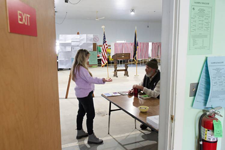 Grafton Selectboard member Steve Darrow, right, talks with supervisor of the checklist Denise Smith, left, during voting at the Grafton, N.H., fire and ambulance station, on Tuesday, March 12, 2024. Darrow, who was appointed to fill a vacant seat on the Selectboard, is on the ballot to finish the two remaining years of the term running against Maureen O'Reilly. (Valley News - James M. Patterson) Copyright Valley News. May not be reprinted or used online without permission. Send requests to permission@vnews.com.
