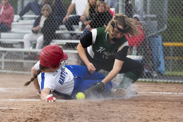 Hartford’s Logan Evans (28) slides into home as Rice’s Bella Messineo (18) attempts to tag her out during a VPA Division II softball quarterfinal game at Maxfield Sports Complex in White River Junction, Vt., on Monday, June 5, 2023. Hartford won, 22-7. (Valley News / Report For America - Alex Driehaus) Copyright Valley News. May not be reprinted or used online without permission. Send requests to permission@vnews.com.