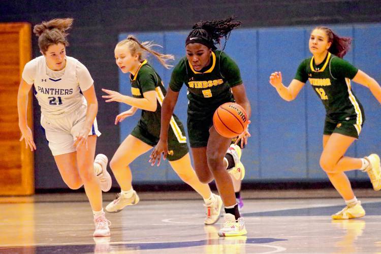 Windsor High's Kemari Wildgoose (5) leads a fast break during her Vermont Division III team's 41-31 defeat of Thetford Academy on Dec. 21, 2023, in Thetford, Vt. Thetford's Charlize Brown (21) and Windsor's Sophia Rockwood (12) and Audrey Rupp trail the play. (Valley News - Tris Wykes) Copyright Valley News. May not be reprinted or used online without permission. Send requests to permission@vnews.com. 