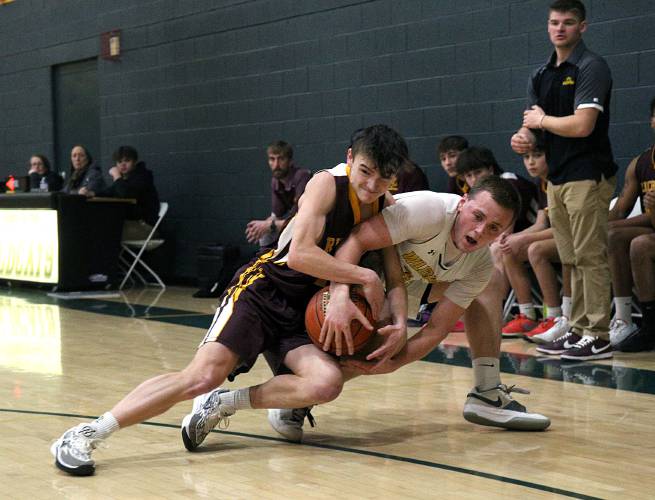White River Valley’s Tattin Griffin, right, is tangled up with Richford’s Jerrick Jacobs while vying for the ball in front of Richford’s bench during their VPA D-III quarterfinal in South Royalton, Vt., on Feb. 24, 2024. The Wildcats won, 84-49. (Valley News - Geoff Hansen) Copyright Valley News. May not be reprinted or used online without permission. Send requests to permission@vnews.com.