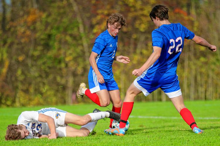 Hartford High's Bryce Soboleski (2) and Morgan Jensen (22) watch Milton's Luke Bushey fall over the ball during the Vermont Division II teams' first-round playoff game on Oct. 25, 2023, in White River Junction. Milton won, 2-1, in double overtime. (Valley News - Tris Wykes) Copyright Valley News. May not be reprinted or used online without permission. Send requests to permission@vnews.com.