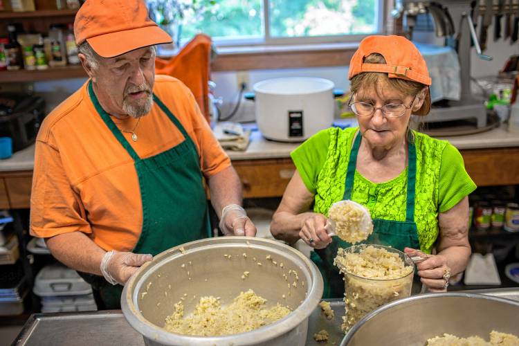 Claremont residents Bill Dillon and Joan Petelle prepare lunches for the second day of The Childrenâs Community Lunch Coalition while volunteering at the Claremont Soup Kitchen and Food Pantry in Claremont, N.H., on June 20, 2016.  (Valley News - Mac Snyder) Copyright Valley News. May not be reprinted or used online without permission. Send requests to permission@vnews.com. 