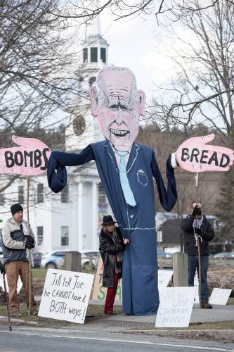 Jill Wilcox, of Sharon, middle, and two other protesters operate a puppet of Joe Biden on the green in Norwich, Vt., as law enforcement departs after a fundraising visit by First Lady Jill Biden to a private home nearby on Tuesday, March 19, 2024. The protest was organized by Upper Valley for Palestine. (Valley News - James M. Patterson) Copyright Valley News. May not be reprinted or used online without permission. Send requests to permission@vnews.com.