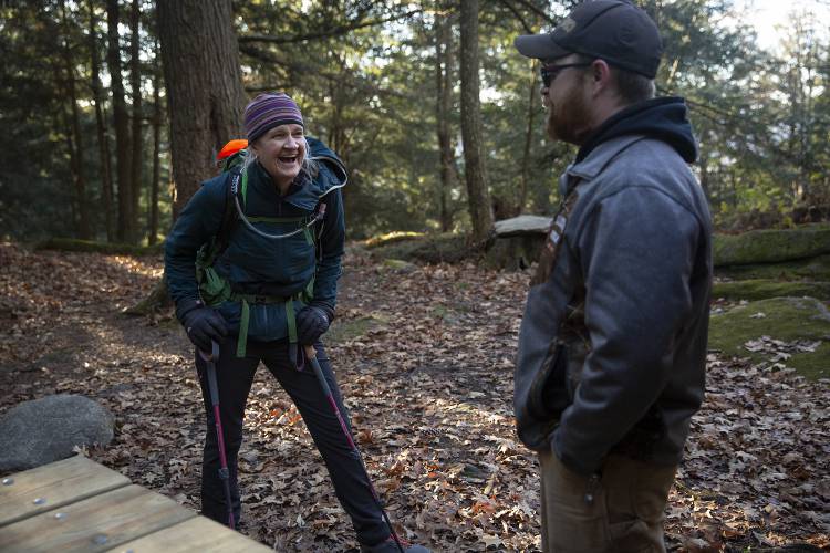 Kate Harrison, left, laughs with David Beane Jr., both of Lyme, N.H., as they take a break from hiking at the Velvet Rocks Shelter on the Appalachian Trail in Hanover, N.H., on Monday, Nov. 20, 2023. Harrison and Beane had never met prior to Harrison donating her kidney, and Beane was unsure whether the donation would actually happen until he was being prepped for surgery in the hospital and received a note from Harrison introducing herself. “It was a very emotional moment,” Beane said. (Valley News / Report For America - Alex Driehaus) Copyright Valley News. May not be reprinted or used online without permission. Send requests to permission@vnews.com.