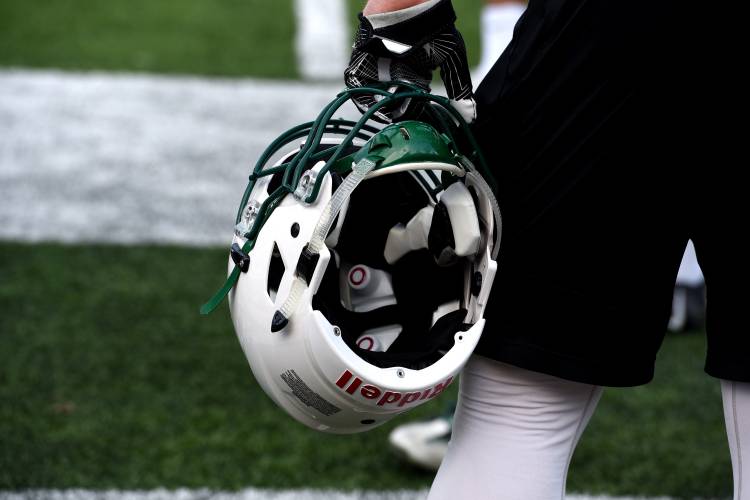 A Dartmouth football player watches from the sideline during a practice in Hanover, N.H, on April 28, 2017. This particular helmet has Simbex sensors in it. (Valley News - Jennifer Hauck) Copyright Valley News. May not be reprinted or used online without permission. Send requests to permission@vnews.com.