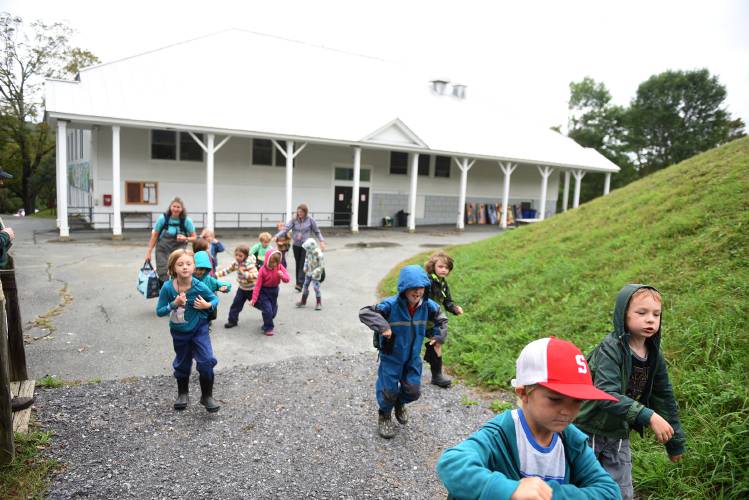 Newton School first graders charge up the hill behind the school to their outdoor classroom on Tuesday, Sept. 19, 2023, in South Strafford, Vt. (Valley News - Jennifer Hauck) Copyright Valley News. May not be reprinted or used online without permission. Send requests to permission@vnews.com.