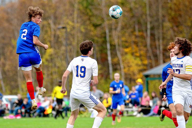 Hartford High's Bryce Soboleski (2) heads the ball past Milton's Keegan Thomas (19) and Tyler Larocque (17) during the Vermont Division II teams' first-round playoff game on Oct. 25, 2023, in White River Junction, Vt. Milton won, 2-1, in two overtimes. (Valley News - Tris Wykes) Copyright Valley News. May not be reprinted or used online without permission. Send requests to permission@vnews.com.