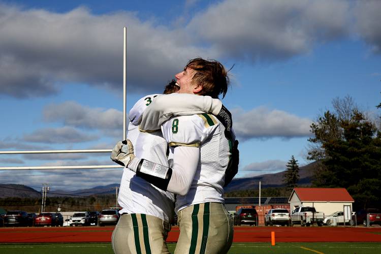 Windsor teammates Gavin Martin, left, and Daniel Haugaard-Steffensen react to their 36-0 Division III state championship win over Woodstock in Rutland, Vt., on Nov. 11, 2023. The Yellowjackets won their third straight title. (Valley News - Geoff Hansen) Copyright Valley News. May not be reprinted or used online without permission. Send requests to permission@vnews.com.