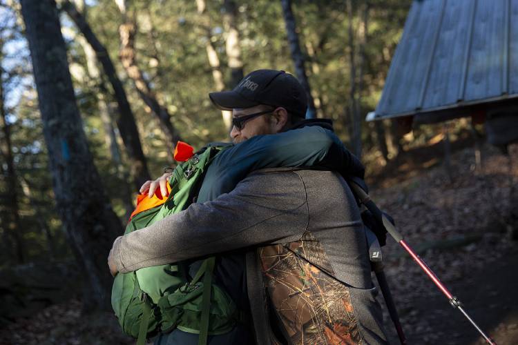 Kate Harrison, left, hugs David Beane Jr., both of Lyme, N.H., before parting ways at the Velvet Rocks Shelter on the Appalachian Trail in Hanover, N.H., on Monday, Nov. 20, 2023. Beane grew up hunting and walking in the woods, but when he was in kidney failure and spending up to 11 hours a day on dialysis going on even a short hike would’ve felt impossible. “It changed my life,” Beane said of Harrison’s donation. (Valley News / Report For America - Alex Driehaus) Copyright Valley News. May not be reprinted or used online without permission. Send requests to permission@vnews.com.