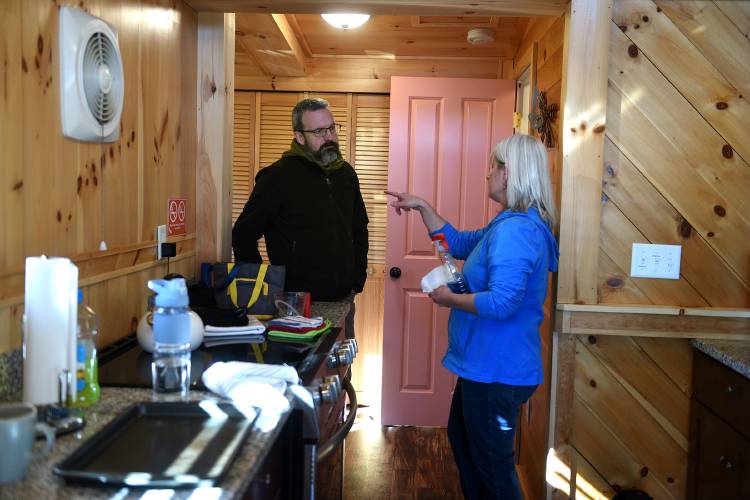 On Thursday, Feb. 8, 2024, Eric and Kathryn Callum, of Unity, N.H., prepare their short-term rental on Mountianview Lake in Sunapee, N.H., for Airbnb guests. The couple also use the property for themselves. (Valley News - Jennifer Hauck) Copyright Valley News. May not be reprinted or used online without permission. Send requests to permission@vnews.com.