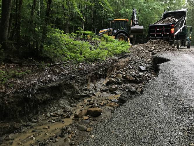 A crew from the Canaan Highway Department works on repairing flood damage on South Road in Canaan, N.H., on Monday, July 10, 2023. South Road is closed between Potato Road and Gristmill Hill Road.