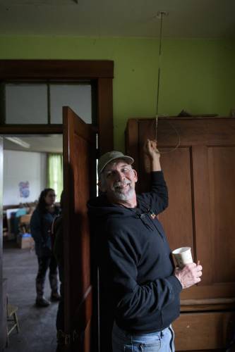 Dan Kinney, of Royalton, rings the bell of the Octagon Schoolhouse on the grounds of the Community Church in East Bethel, Vt., after giving a tour of the disused building on Sunday, Oct. 22, 2024. (Valley News - James M. Patterson) Copyright Valley News. May not be reprinted or used online without permission. Send requests to permission@vnews.com.