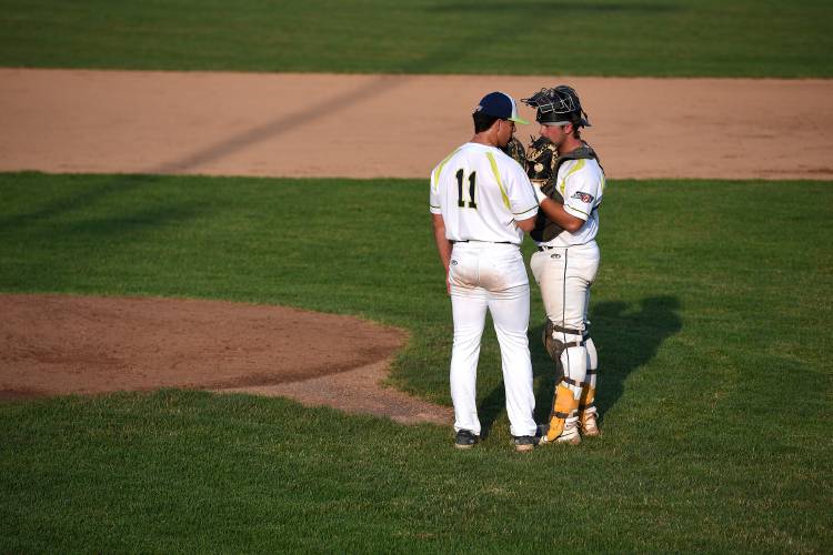 Nighthawks pitcher Patrick Gardner, left, and catcher Bear Madliak talk briefly before Gardner takes to the mound in the third inning on Wednesday, July 5, 2023, in White River Junction, Vt. Gardner, a student at Fairleigh Dickinson University, threw 3 2/3 innings of shutout ball with five strikeouts in his debut with the team on Wednesday night. 
 (Valley News - Jennifer Hauck) Copyright Valley News. May not be reprinted or used online without permission. Send requests to permission@vnews.com.