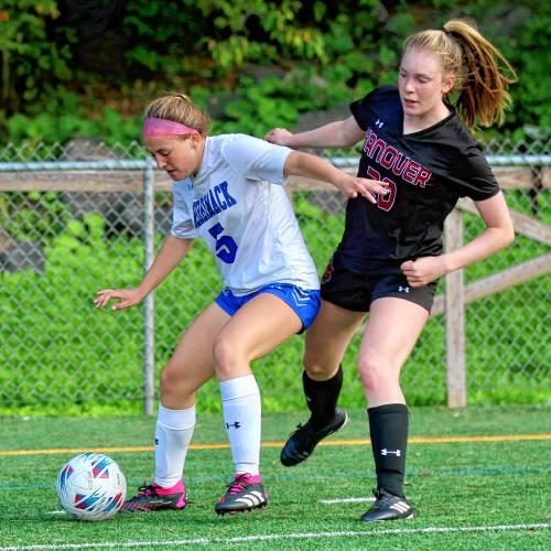 Hanover High's Sydney McLaughlin, right, peers around Merrimack's Danielle Ganley during the NHIAA Division II teams' Sept. 26, 2023, game on Merriman-Branch Field in Hanover, N.H. Hanover won, 2-1. (Valley News - Tris Wykes) Copyright Valley News. May not be reprinted or used online without permission. Send requests to permission@vnews.com 