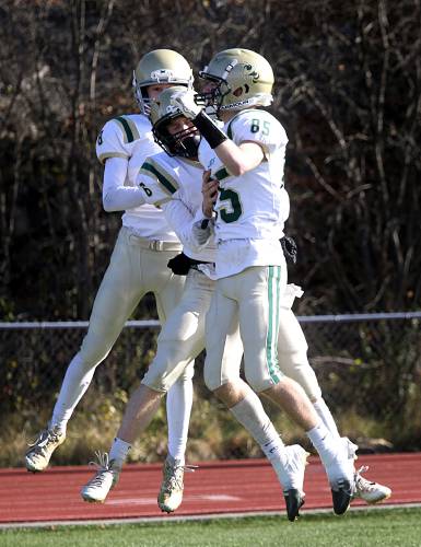 From left, Daniel Haugaard-Steffensen, Corey Lockwood and Anthony Cook celebrate Lockwood's second quarter touchdown in the Division III state championship against Woodstock in Rutland, Vt., on Nov. 11, 2023. Windsor blanked Woodstock 36-0 to win their third straight title. (Valley News - Geoff Hansen) Copyright Valley News. May not be reprinted or used online without permission. Send requests to permission@vnews.com.
