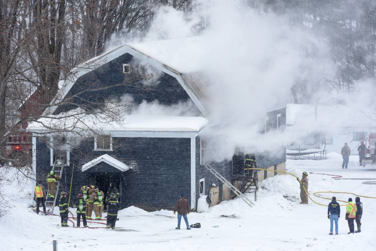 Fire departments from Bethel, South Royalton, Randolph Center, East Randolph and Barnard work to save the Middle Branch Grange building from a fire that started in the wood heating system in East Bethel, Vt., on Saturday, Jan. 20, 2024. Bethel Fire Chief David Aldrighetti said that a portion of the building is not structurally safe after being damaged by fire and water. 