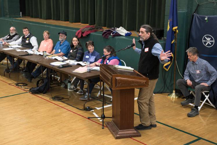 State Rep. Kirk White, D-Bethel, speaks at Town Meeting about consumer privacy legeslation that he is sponsoring, as Bethel, Vt., officials wait to take up town business on Tuesday, March 5, 2024. Moderator Rick Benson, right, won re-election by write-in vote, but declined the position. (Valley News - James M. Patterson) Copyright Valley News. May not be reprinted or used online without permission. Send requests to permission@vnews.com.