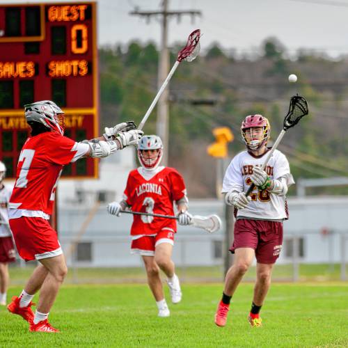 Lebanon High's Evan George (28) throws a pass beyond Laconia's Brady Stevens (27) while the Sachems' Paul Ganchi (3) trails the play at Henry Emerton Field in Lebanon, N.H. Laconia won the NHIAA Division III teams' meeting, 8-2, on April 17, 2024. (Valley News - Tris Wykes) Copyright Valley News. May not be reprinted or used online without permission. Send requests to permission@vnews.com. 